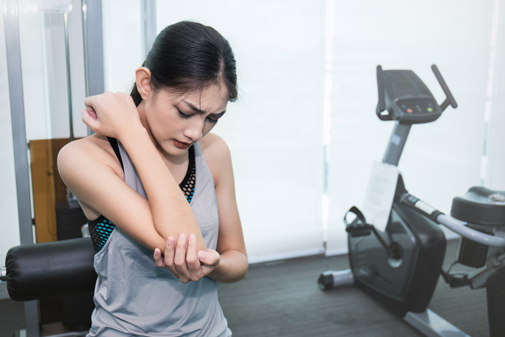 young asian girl suffer arm pain