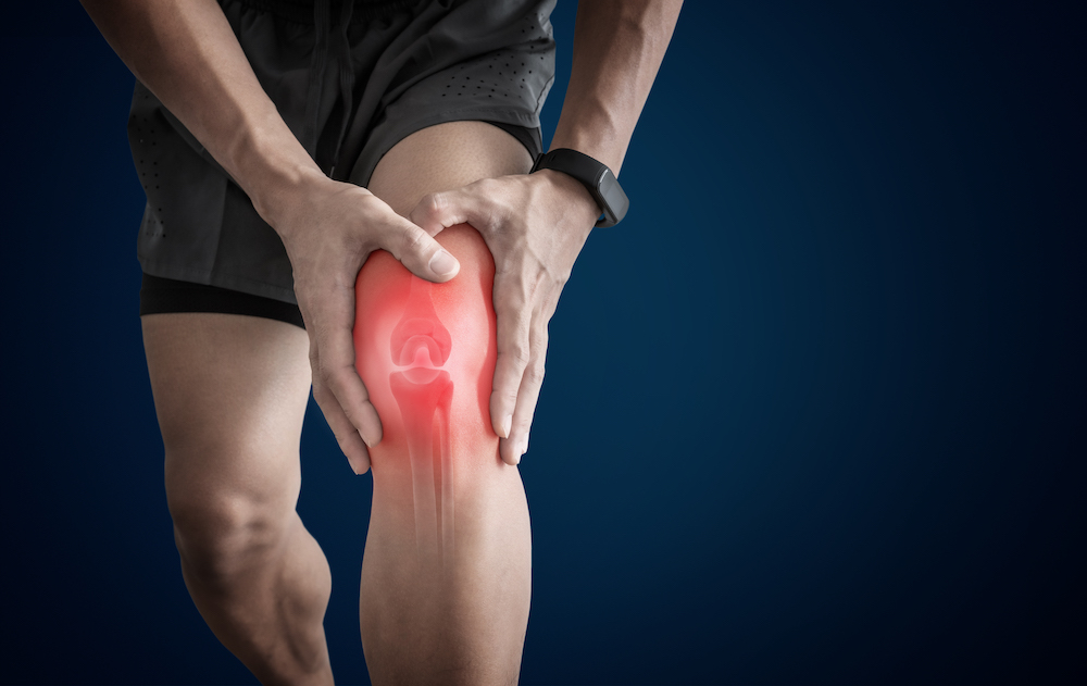 man suffering from overuse injury pain on his knee