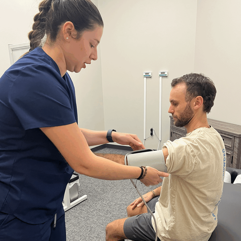 female medical practitioner checking patients pressure
