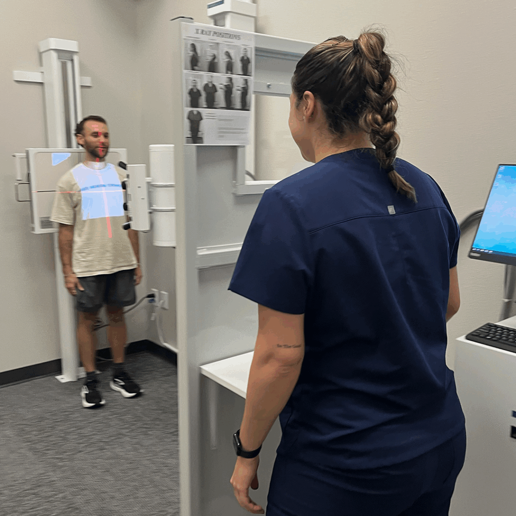 medical practitioner doing xray to male patient