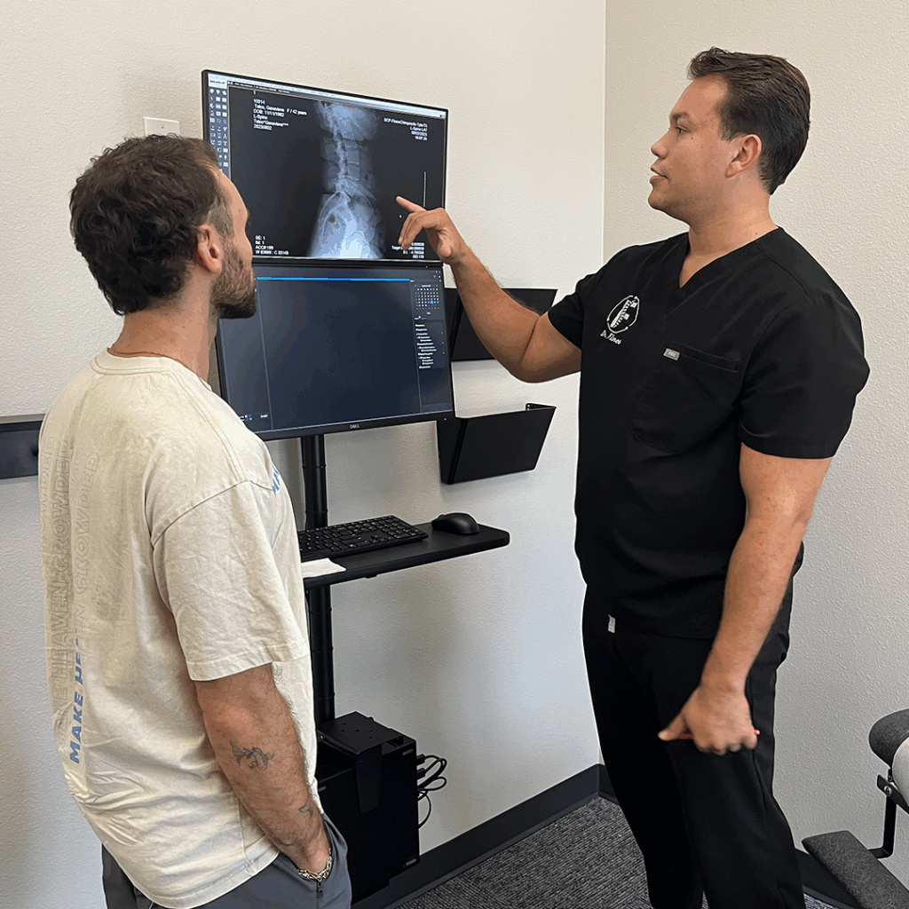 Dr. Ricardo Flores showing male patient digital spine xray result